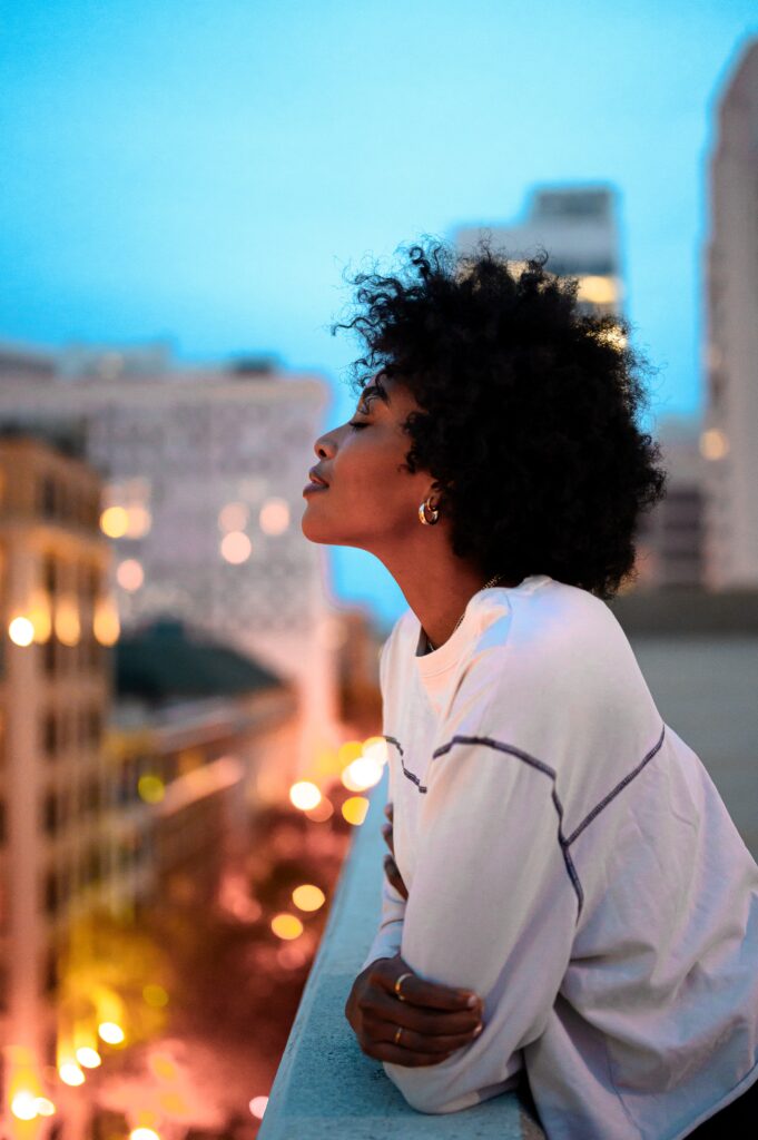 Lady relaxing on balcony to improve mental health and wellbeing